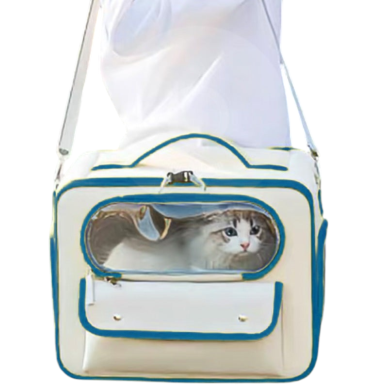 The Tailored Tail beige pet travel trolley bag with a transparent window carrying a cat, worn as a shoulder bag.