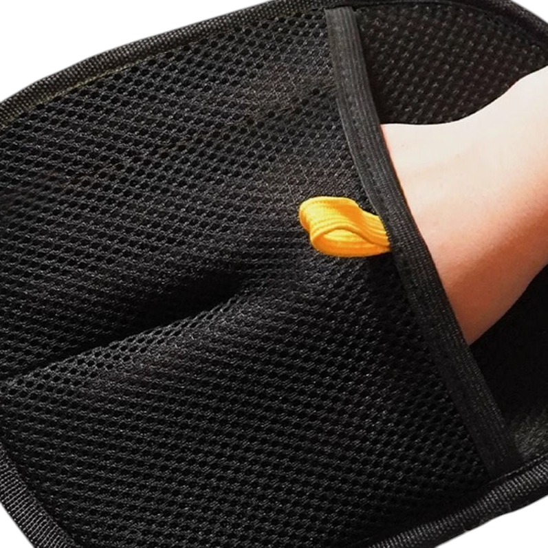 The Tailored Tail black electrostatic pet hair removal glove with mesh fabric and a yellow pull tab