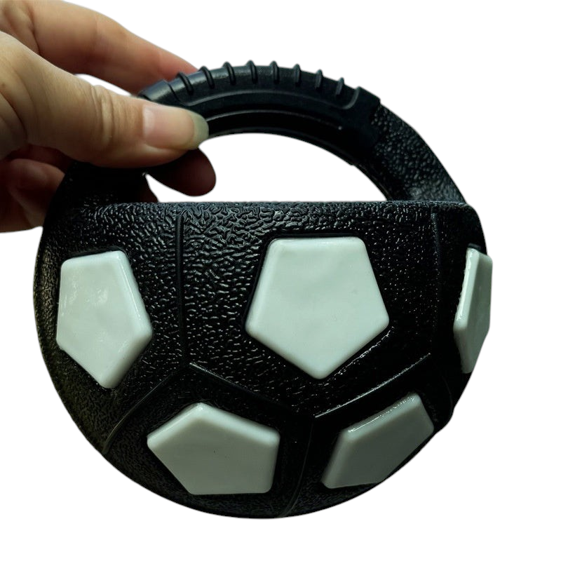 The Tailored Tail black and white bite-resistant TPR interactive dog fetch ball with a convenient handheld handle.