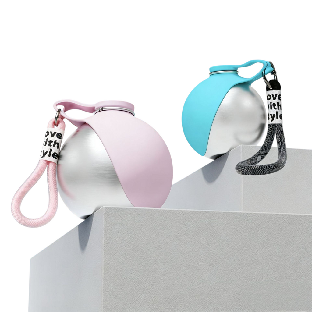 The Tailored Tail collapsible pet water bottles in pink and blue with stainless steel interior and carrying hooks