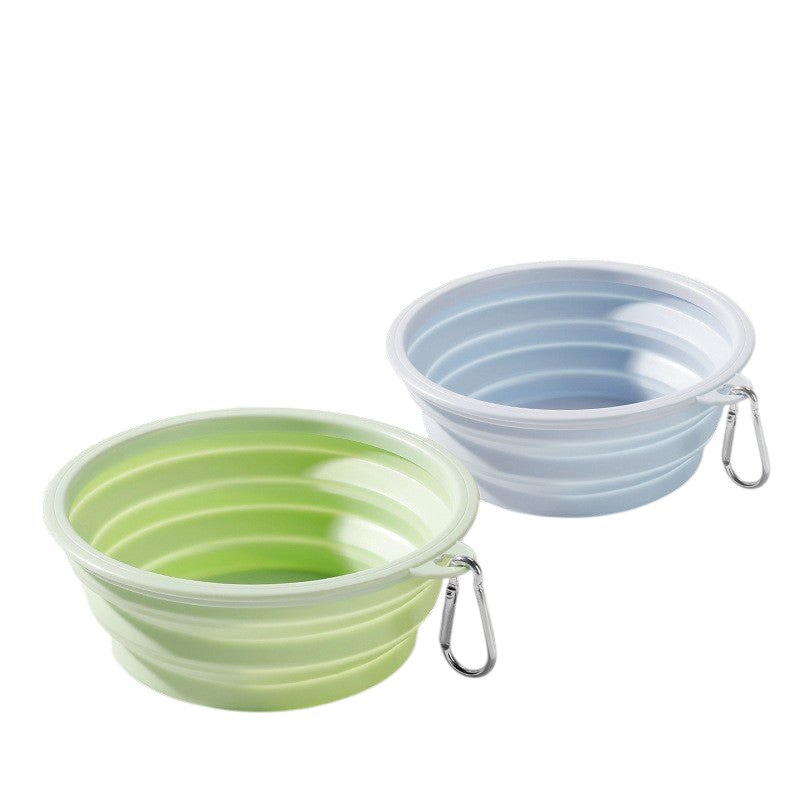 The Tailored Tail foldable silicone pet bowls in green and blue with attached metal carabiner clips for travel.