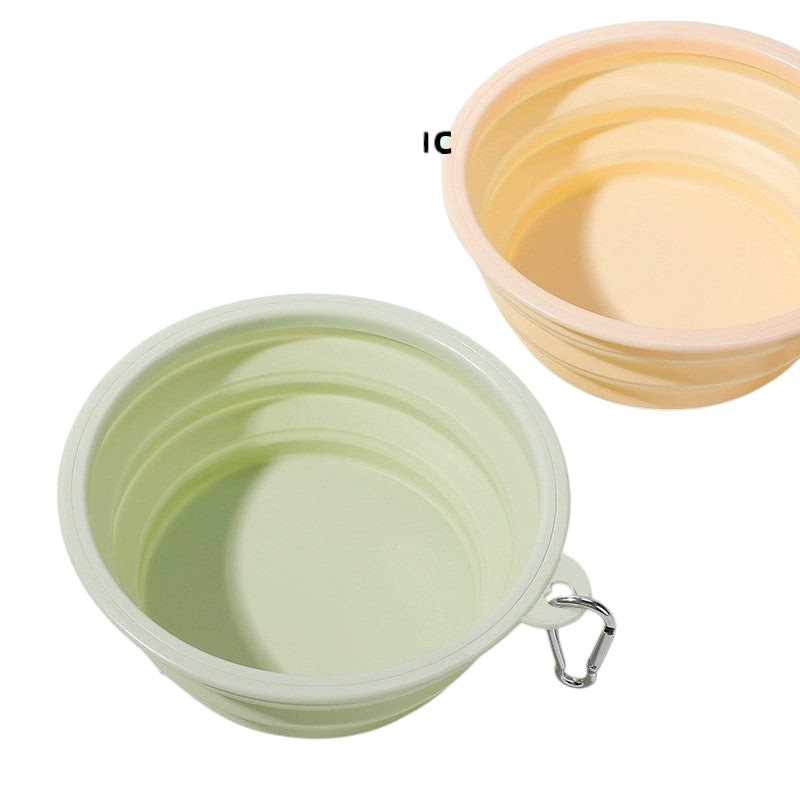 The Tailored Tail foldable silicone pet bowls in light green and yellow with attached carabiner clips
