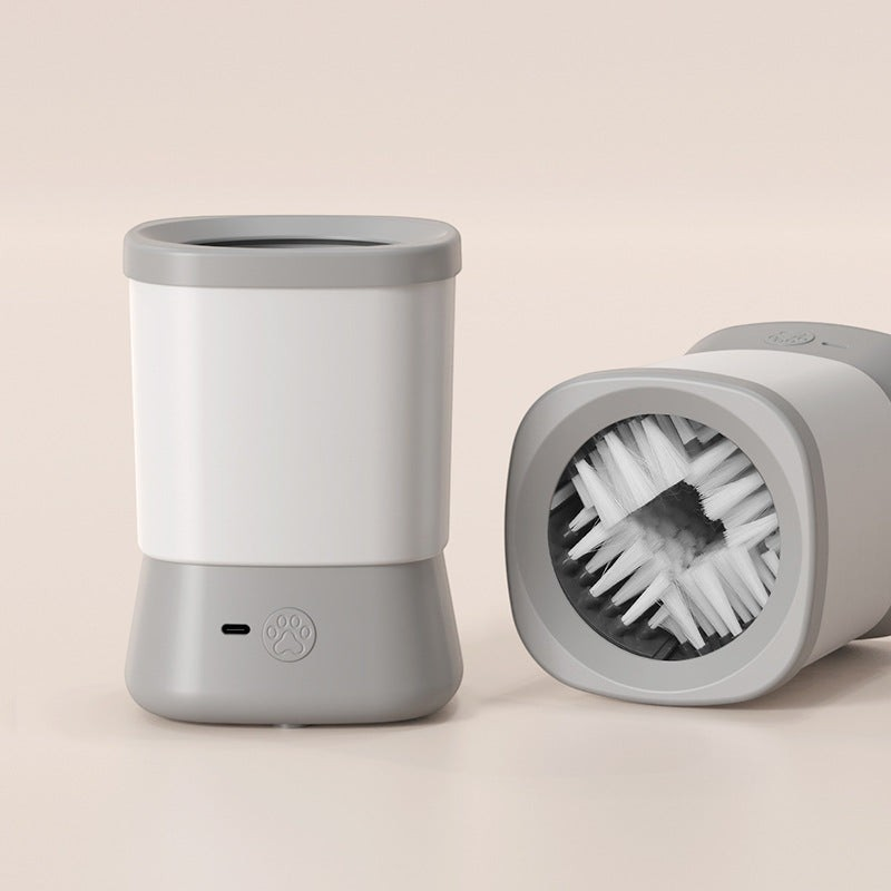 The Tailored Tail electric pet paw cleaner in white and gray with soft internal cleaning bristles.
