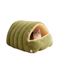 The Tailored Tail green corduroy cave-style cat bed with a plush interior and a cat resting inside.