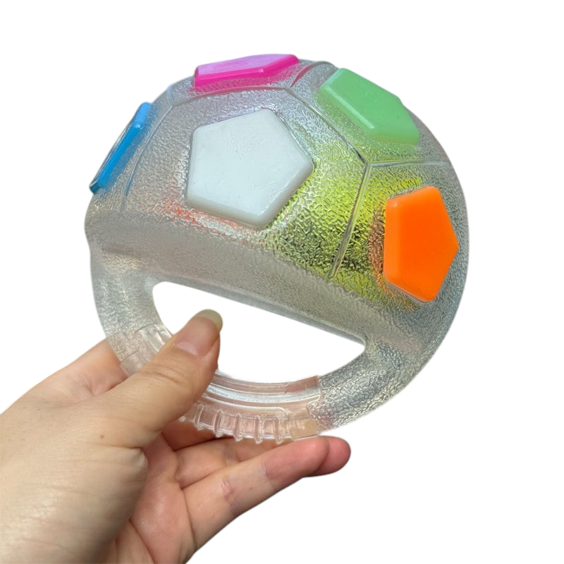 The Tailored Tail interactive dog fetch ball made of clear bite-resistant TPR with colorful pentagon inserts