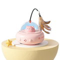 The Tailored Tail electric UFO cat teaser toy in cherry blossom pink with a feather wand and bell on a yellow stand.