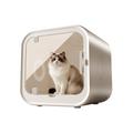 The Tailored Tail silent pet drying box with a fluffy cat inside, featuring a sleek white design and clear door.