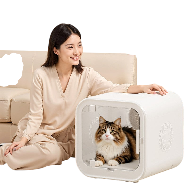 The Tailored Tail silent pet drying box with a fluffy cat inside, sitting next to a smiling woman on a sofa.