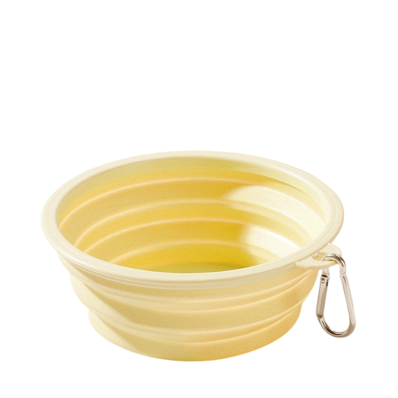 The Tailored Tail yellow foldable silicone pet bowl with a metal carabiner clip for travel.